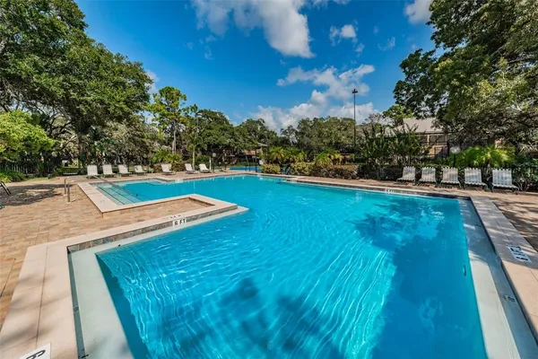 a view of a swimming pool with a table and chairs