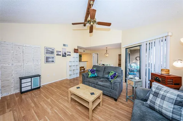a living room with furniture and wooden floor