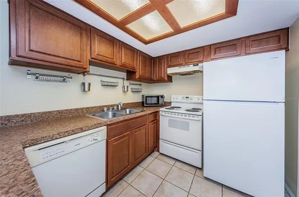 a kitchen with stainless steel appliances granite countertop a refrigerator sink and cabinets