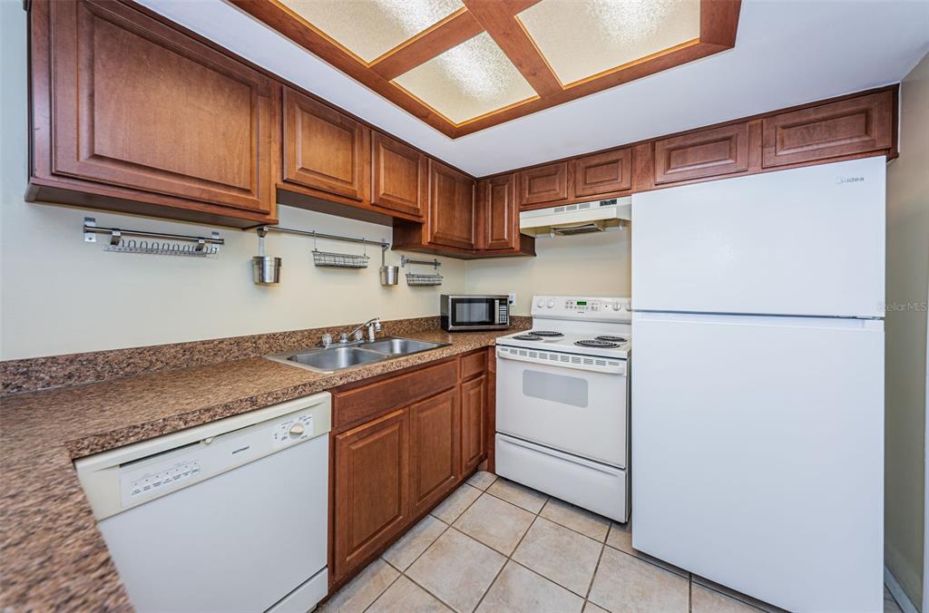 802 Lennox Road West, Unit 802 Palm Harbor, FL 34683 - Photo 8 of 42 a kitchen with stainless steel appliances granite countertop a refrigerator sink and cabinets