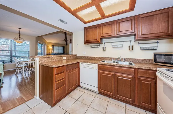 a kitchen with stainless steel appliances granite countertop a sink and cabinets