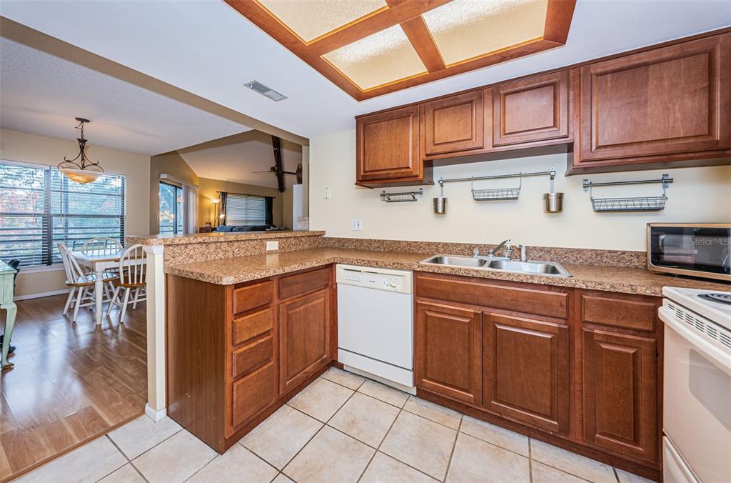 802 Lennox Road West, Unit 802 Palm Harbor, FL 34683 - Photo 9 of 42 a kitchen with stainless steel appliances granite countertop a sink and cabinets