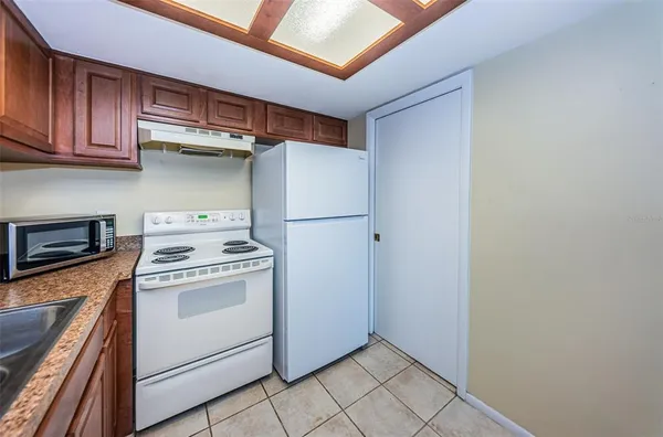 a kitchen with a stove top oven and cabinets