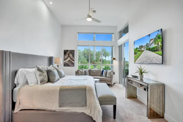 a bedroom with a bed and a painting on the wall