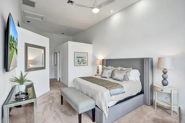 a bedroom with a bed and a painting on the wall