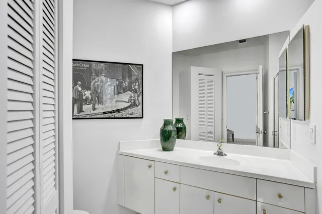 a patio table and chairs with potted plants