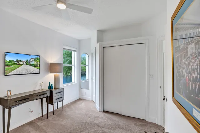 a view of a house with a yard and potted plants