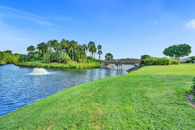 a aerial view of a house with a garden and lake view