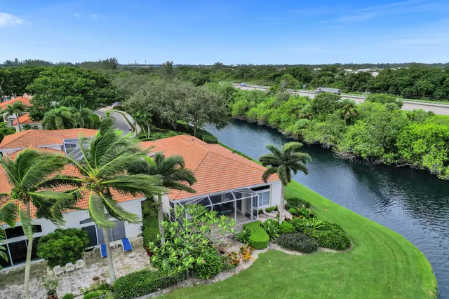 a view of a swimming pool with a garden and patio
