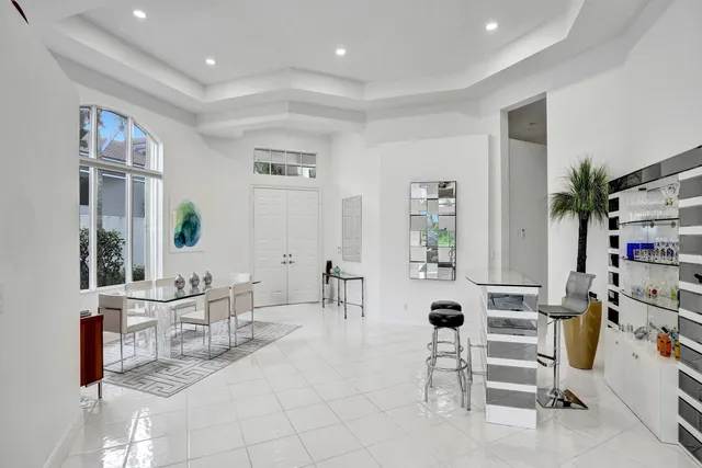 a living room with furniture a table and a potted plant