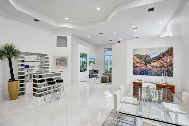 a living room with furniture a flat screen tv and potted plant