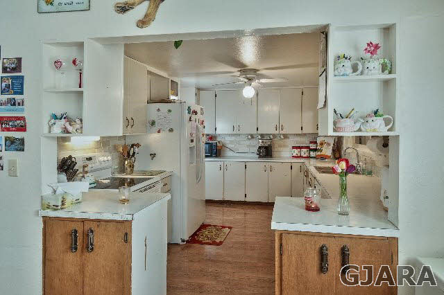 1404 Q Road Loma, CO 81524 - Photo 4 of 31 a kitchen with kitchen island a sink stove and refrigerator