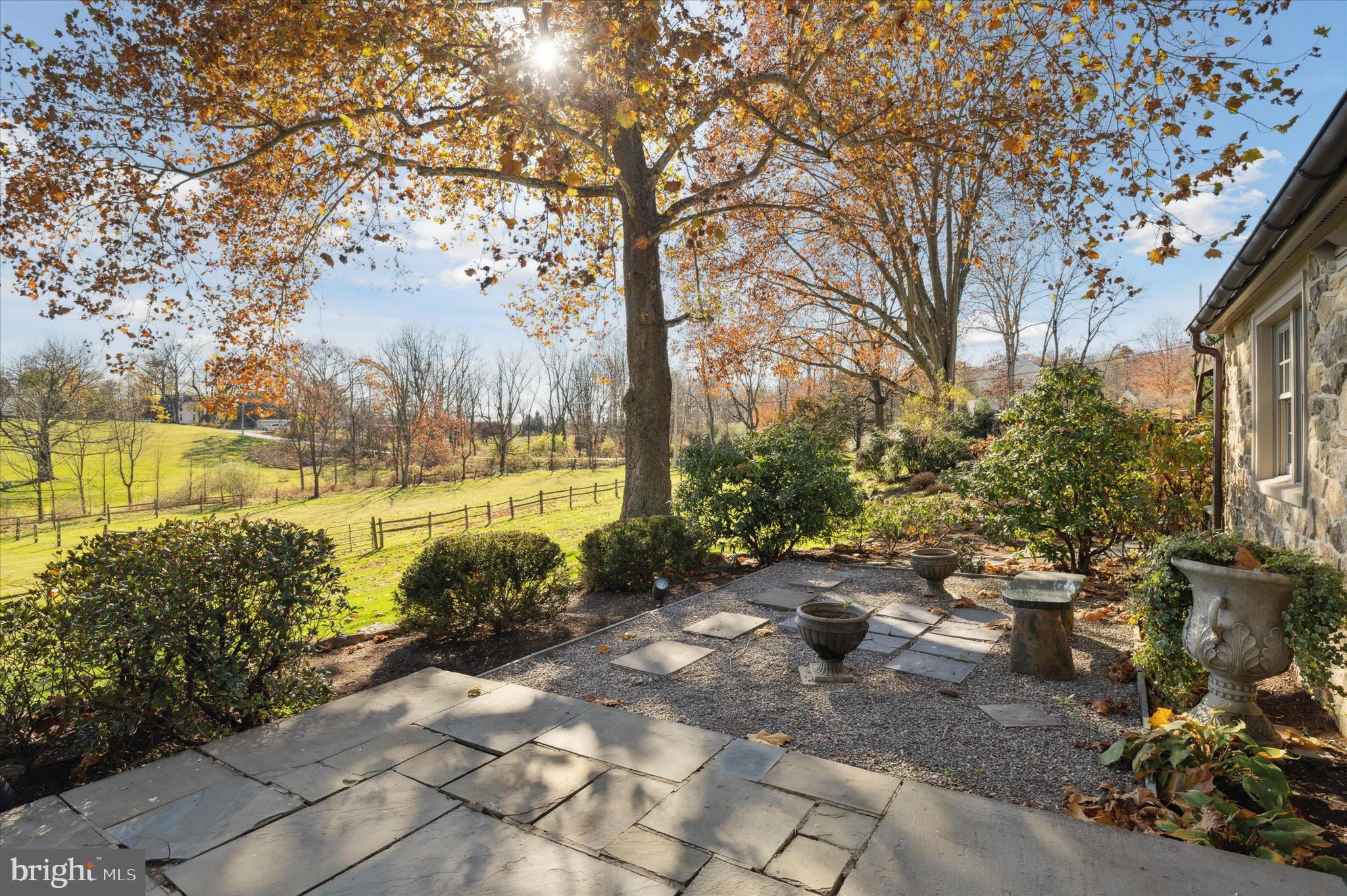 2 Fox Run Road Chester Springs, PA 19425 - Photo 11 of 103 a view of a patio with table and chairs under an umbrella
