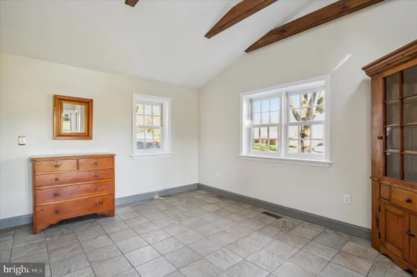a view of empty room with wooden floor and fireplace