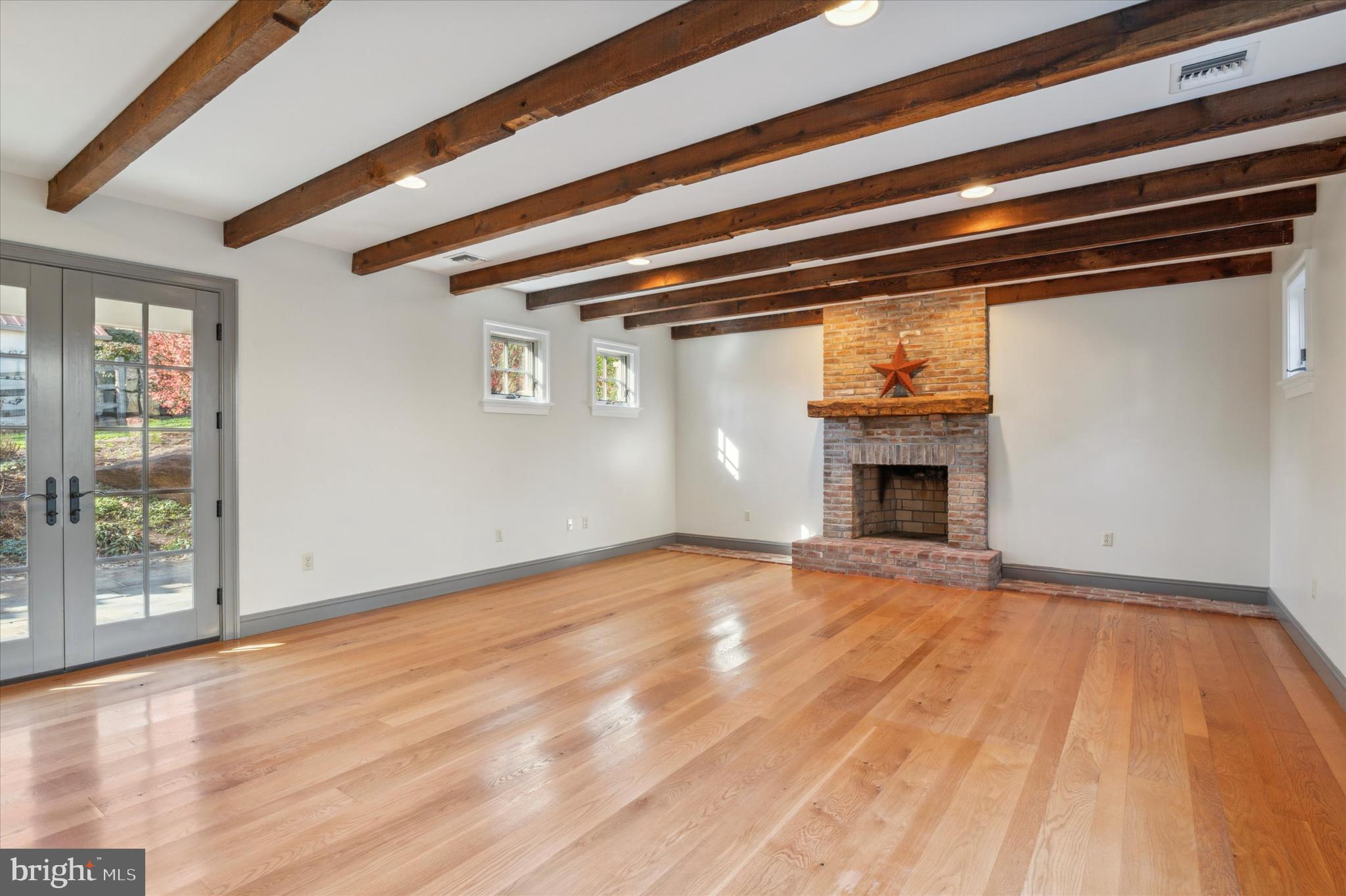 2 Fox Run Road Chester Springs, PA 19425 - Photo 28 of 103 a view of empty room with wooden floor and fireplace