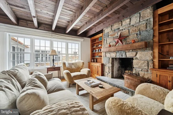 a kitchen with a stove a sink dishwasher a dining table and chairs with wooden floor