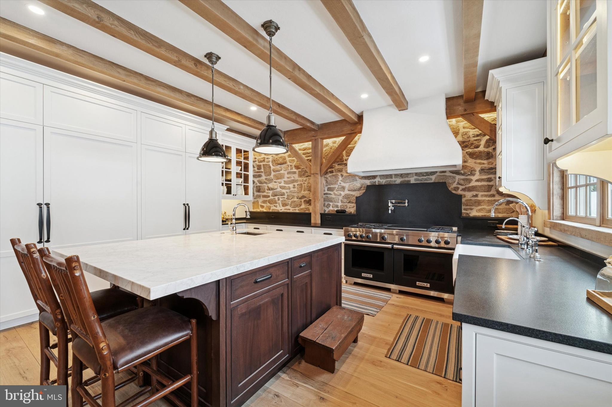 2 Fox Run Road Chester Springs, PA 19425 - Photo 4 of 103 a kitchen with a stove a sink dishwasher a dining table and chairs with wooden floor