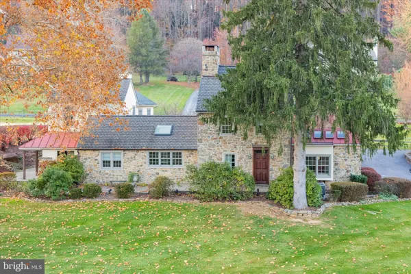 a view of a house with a yard and a tree