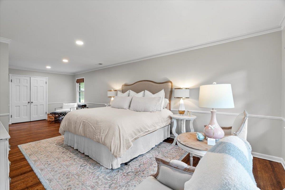 4491 Garnett Road Memphis, TN 38117 - Photo 14 of 32 Spacious room featuring hardwood flooring, recessed lighting, crown molding, double paneled doors, and a window with a roller shade
