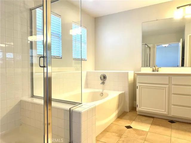 a spacious bathroom with a sink a mirror and a bathtub