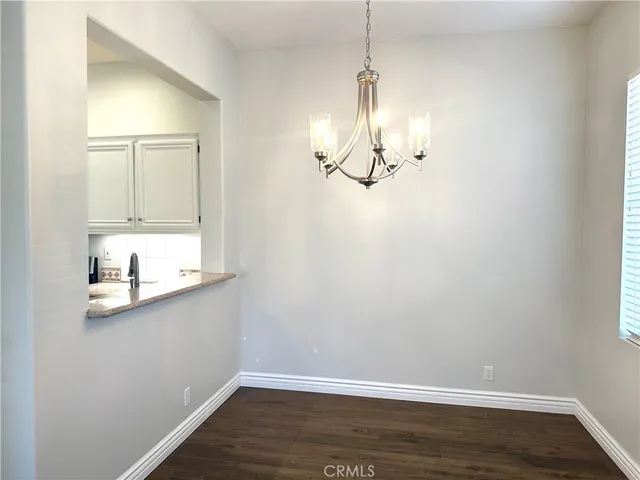 a view of a room with wooden floor closet and windows