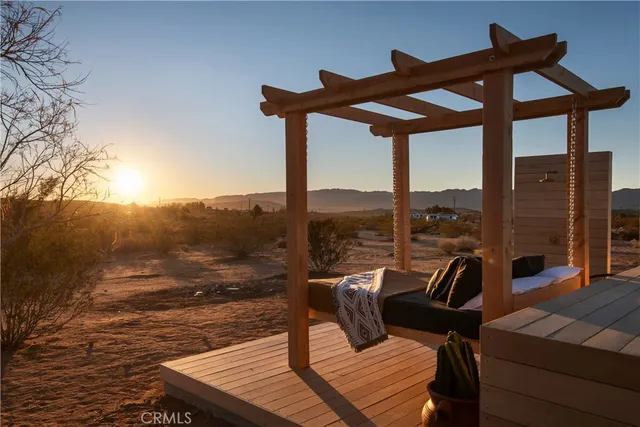 a view of a balcony with furniture and a floor to ceiling window