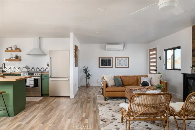 a living room with furniture and a refrigerator