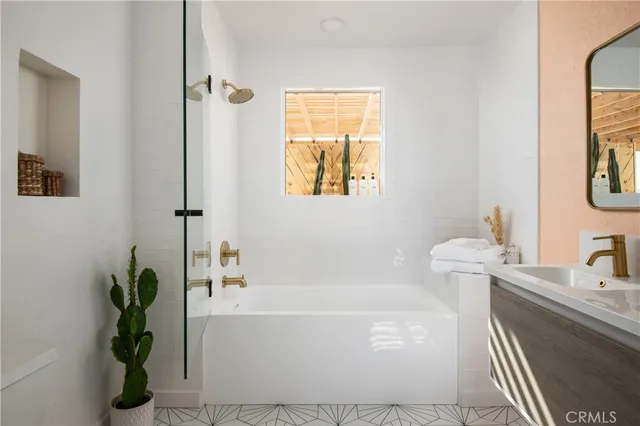 a white bath tub sitting next to a white sink