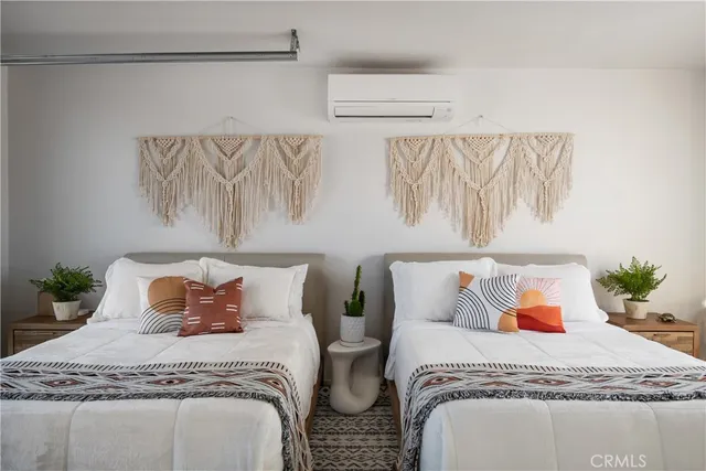 a bedroom with two beds and painted wall