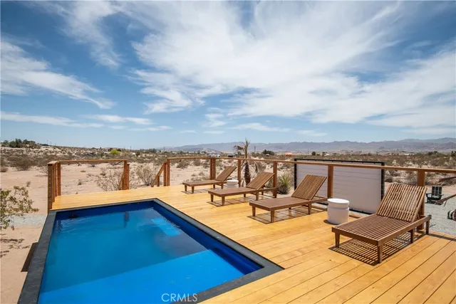 a view of a terrace with couches and sky view