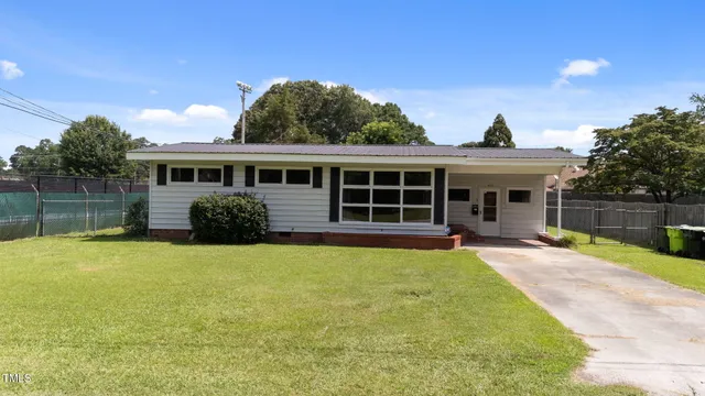 a view of house with backyard and swimming pool