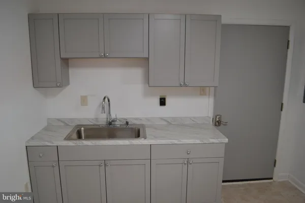 a kitchen with a sink and cabinets