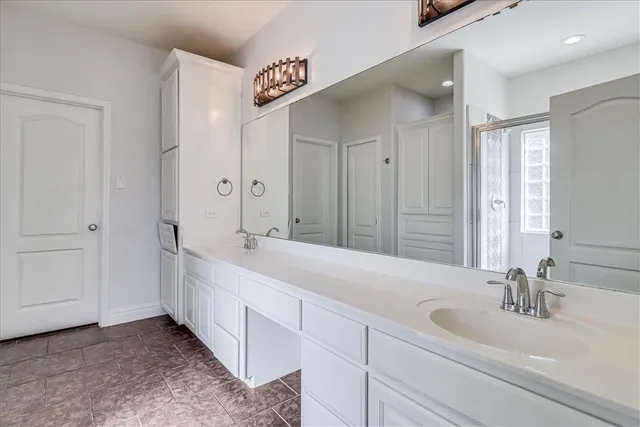 a bathroom with a double vanity sink and a mirror