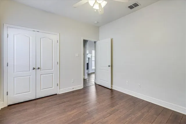 a view of wooden floor and windows in a room