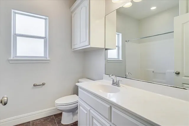 a bathroom with a sink toilet and vanity