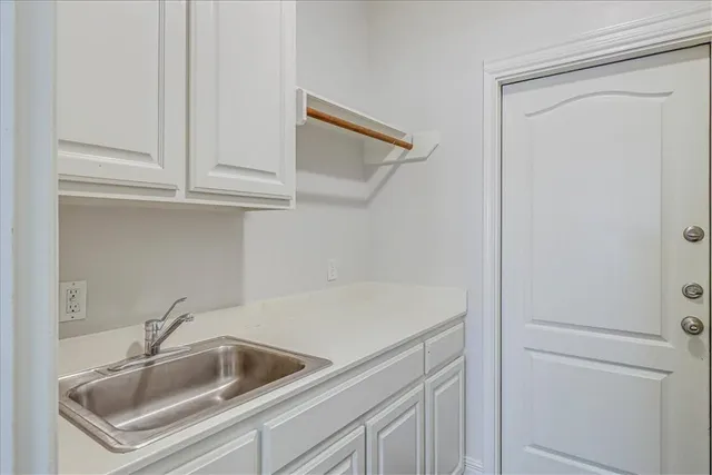 a kitchen with a sink and cabinets