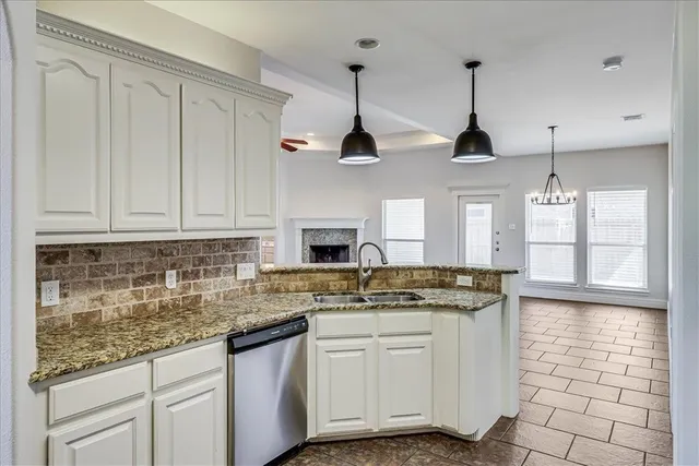 a kitchen with stainless steel appliances granite countertop a sink a counter space and cabinets