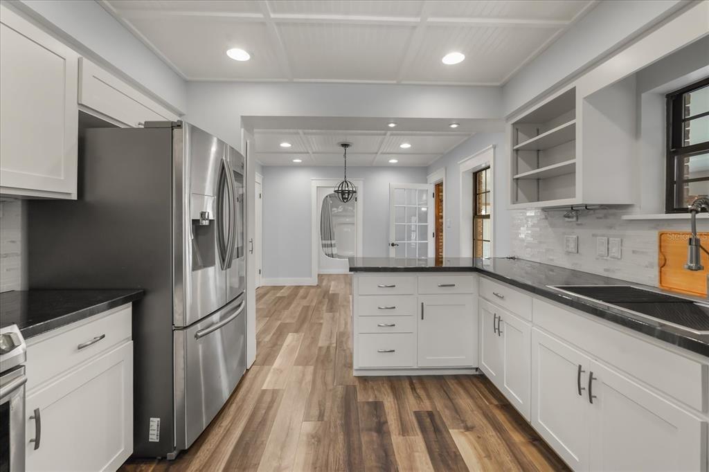3303 Massee Road Davenport, FL 33837 - Photo 11 of 40 a kitchen with white cabinets and refrigerator