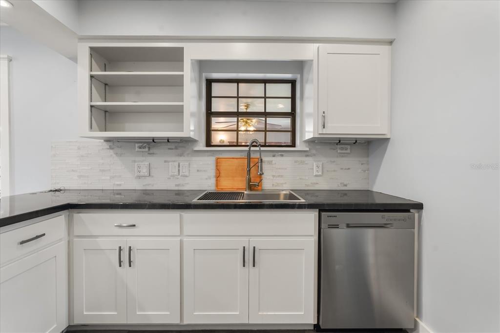 3303 Massee Road Davenport, FL 33837 - Photo 12 of 40 a kitchen with granite countertop white cabinets and window