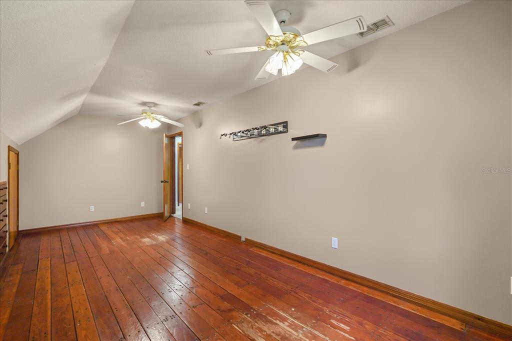 3303 Massee Road Davenport, FL 33837 - Photo 16 of 40 a view of an empty room with wooden floor
