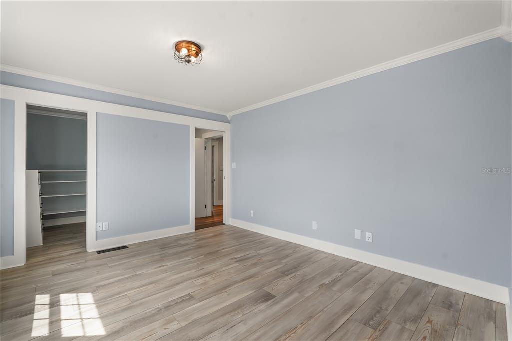 3303 Massee Road Davenport, FL 33837 - Photo 19 of 40 a view of an empty room with wooden floor and closet