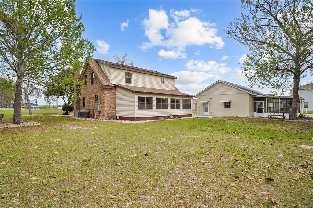 3303 Massee Road Davenport, FL 33837 - Photo 2 of 40 a front view of a house with a garden