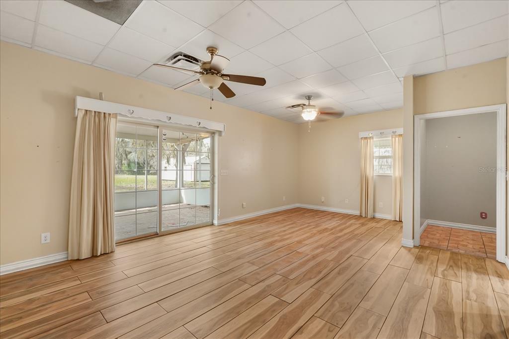 3303 Massee Road Davenport, FL 33837 - Photo 30 of 40 a view of empty room with wooden floor and fan