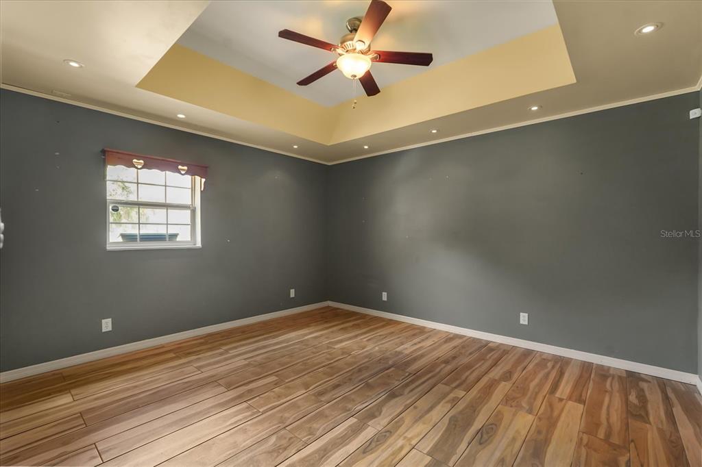 3303 Massee Road Davenport, FL 33837 - Photo 31 of 40 wooden floor in an empty room with a window