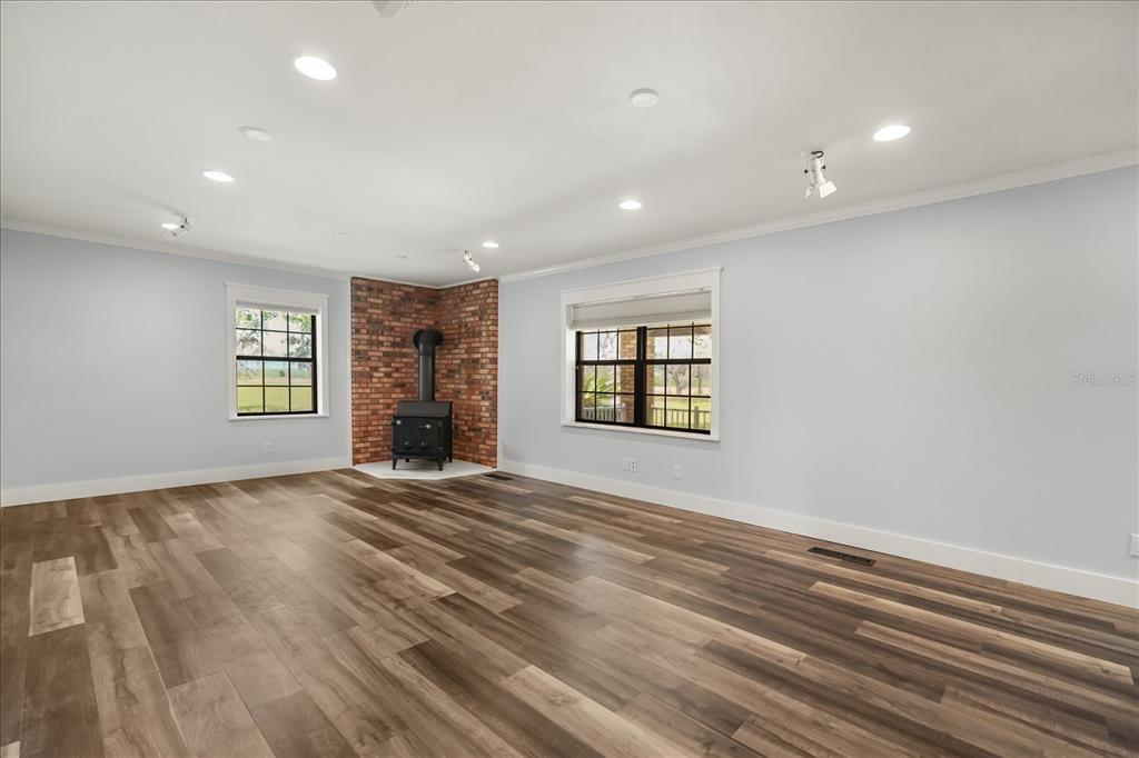 3303 Massee Road Davenport, FL 33837 - Photo 5 of 40 an empty room with windows and fireplace