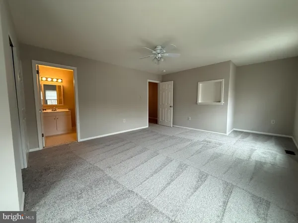 a view of empty room with a fireplace