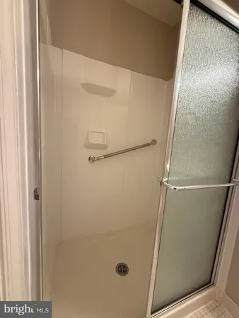 a bathroom with a glass door shower