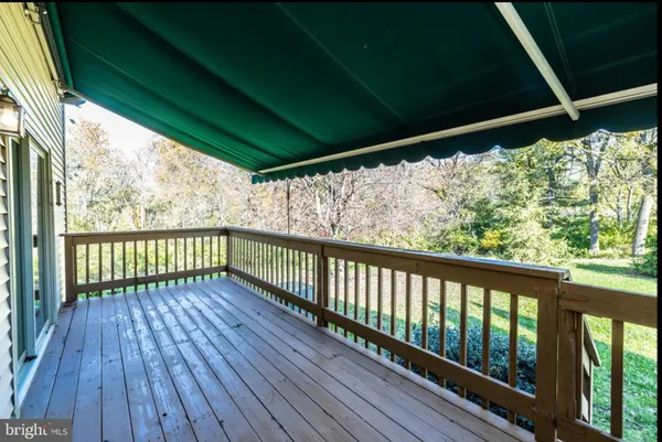 a view of a porch with wooden floor