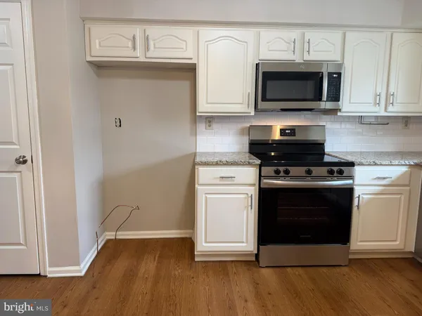 a kitchen with a stove and a microwave