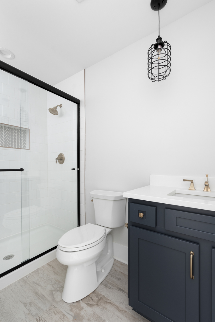 635 North Main Street Naperville, IL 60563 - Photo 11 of 26 a bathroom with a toilet a sink and a shower